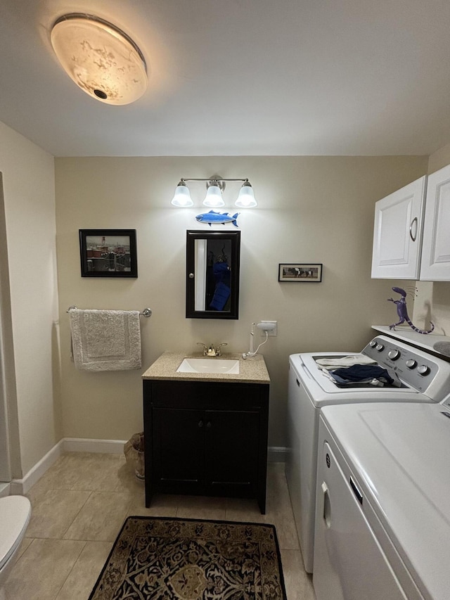 clothes washing area featuring separate washer and dryer, light tile patterned floors, and sink