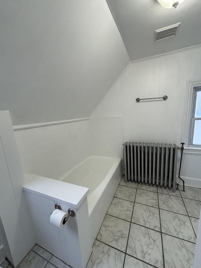 bathroom with a bathing tub and radiator heating unit