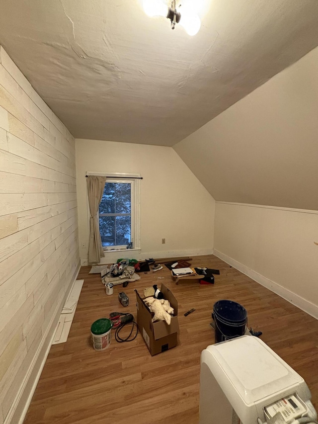 bonus room featuring wood-type flooring and vaulted ceiling