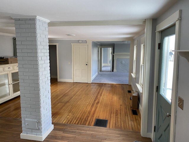 corridor with wood-type flooring and crown molding