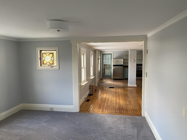 hallway featuring crown molding and carpet