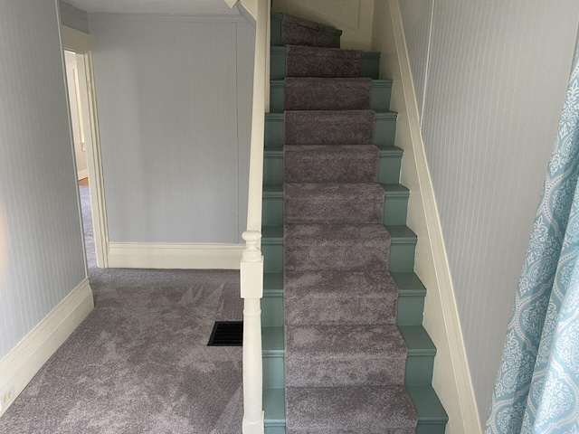 staircase featuring carpet flooring