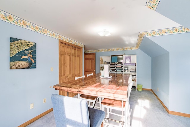 dining room featuring light carpet