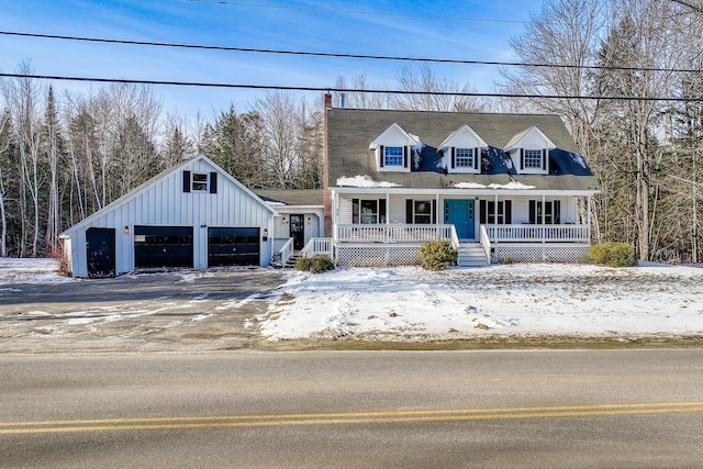 cape cod home featuring a garage and a porch