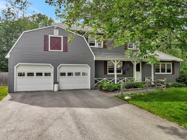 view of front of home with a front yard and a garage