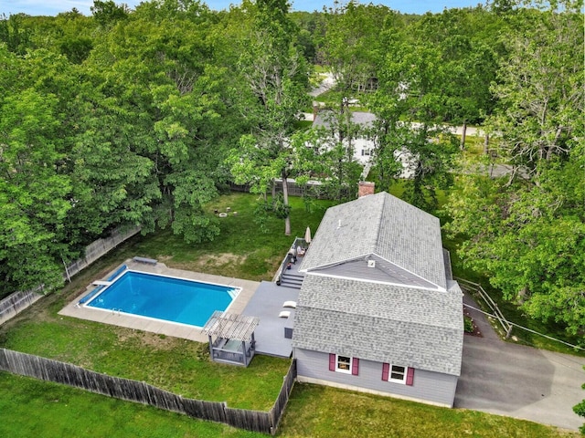 view of swimming pool with a diving board and a lawn