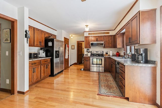 kitchen featuring sink, light hardwood / wood-style flooring, and appliances with stainless steel finishes