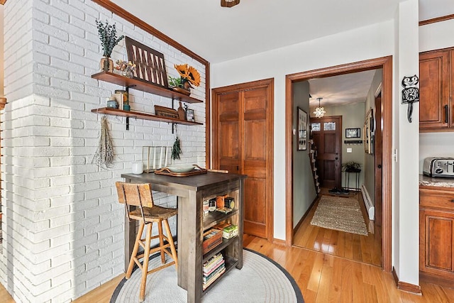 bar with light hardwood / wood-style floors and a baseboard radiator