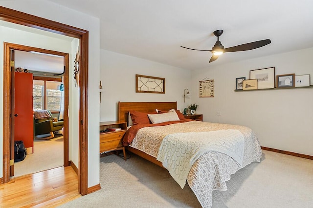 bedroom featuring ceiling fan and light carpet