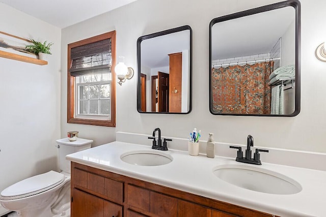 bathroom featuring toilet and vanity