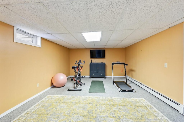 workout area featuring a baseboard heating unit and a drop ceiling