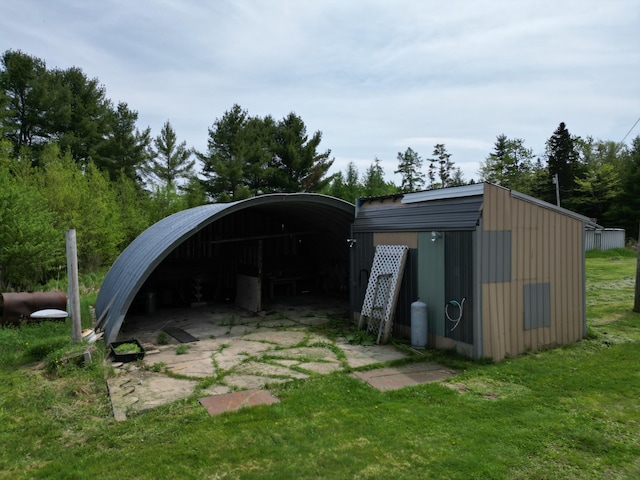 view of outbuilding with a lawn