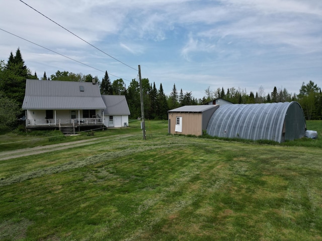 view of yard featuring covered porch and an outdoor structure