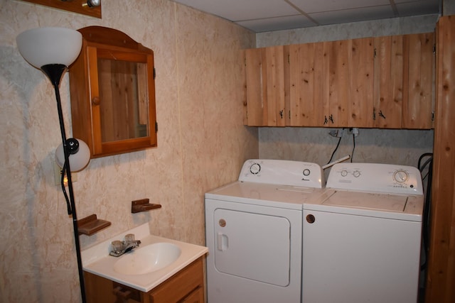 clothes washing area with separate washer and dryer and sink