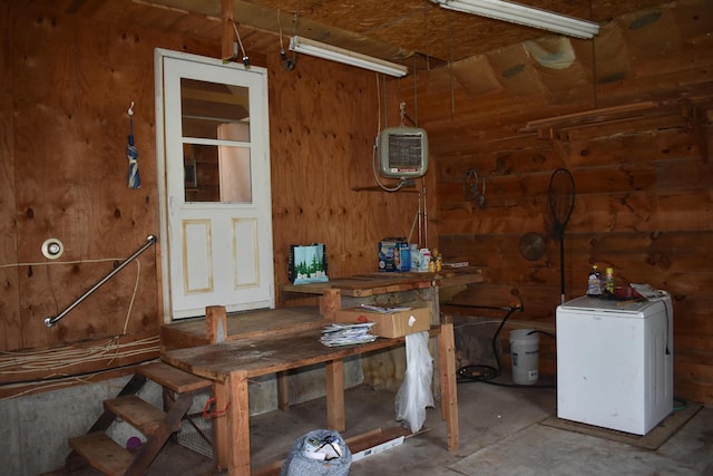 unfurnished dining area featuring a workshop area and wood walls