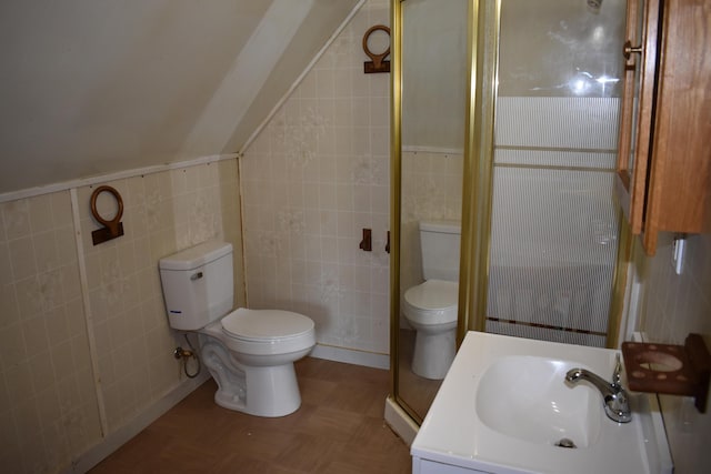 bathroom featuring toilet, a shower with door, parquet flooring, tile walls, and sink