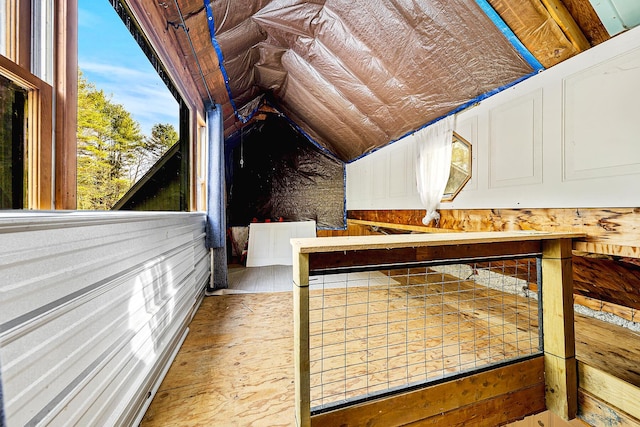 unfurnished bedroom with vaulted ceiling and wood-type flooring