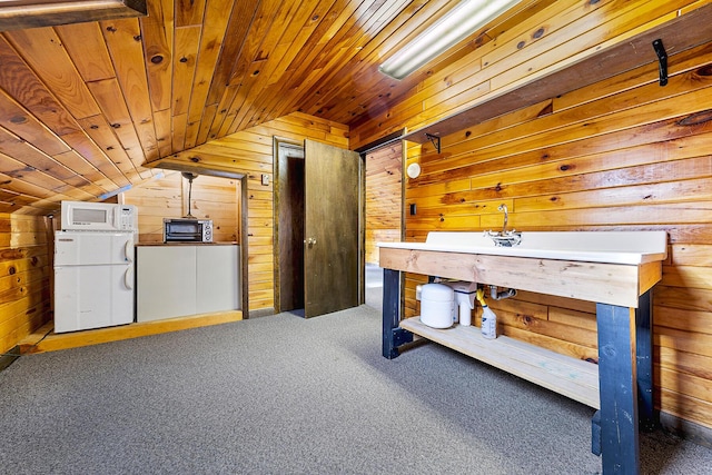 interior space featuring wooden walls, wooden ceiling, and vaulted ceiling