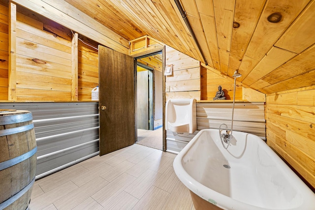 bathroom featuring wooden ceiling, wood walls, lofted ceiling, and a bathing tub