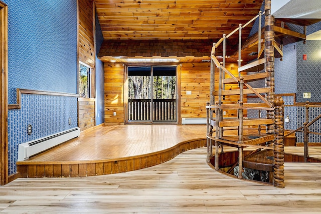 interior space featuring lofted ceiling, a baseboard radiator, wood ceiling, and hardwood / wood-style floors