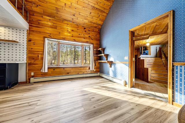 unfurnished living room with baseboard heating, light hardwood / wood-style flooring, and high vaulted ceiling