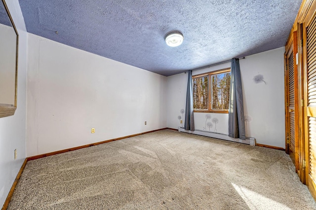 unfurnished bedroom featuring a baseboard radiator, a textured ceiling, and light carpet