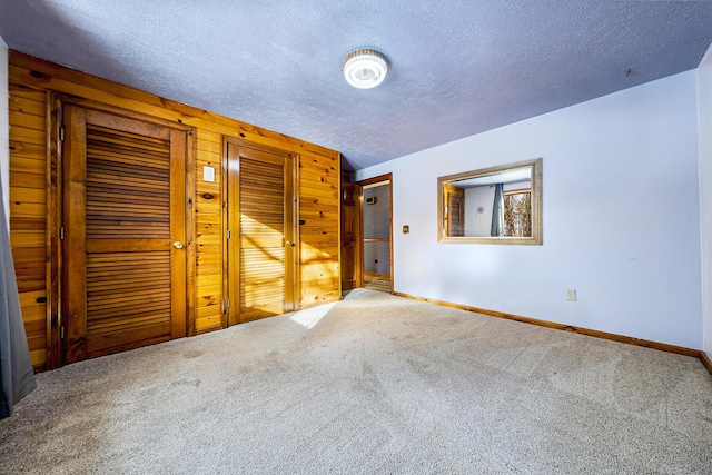 carpeted spare room with a textured ceiling