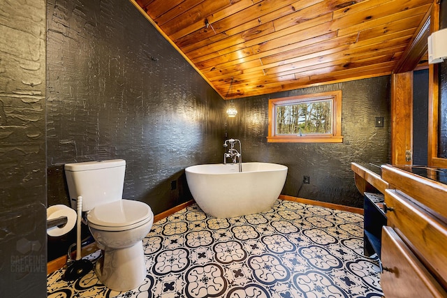 bathroom featuring lofted ceiling, toilet, a washtub, and wood ceiling