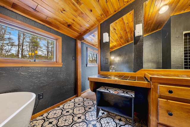 bathroom featuring vanity, wood ceiling, vaulted ceiling, and a bath