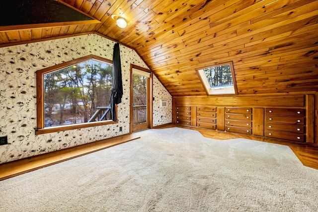 additional living space featuring vaulted ceiling with skylight and wood ceiling