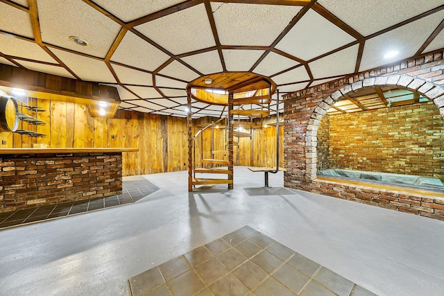 basement with brick wall and wooden walls