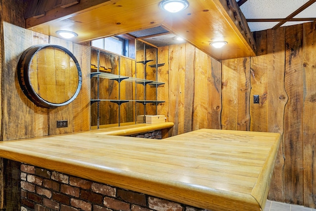 interior space with wooden walls and tile patterned flooring