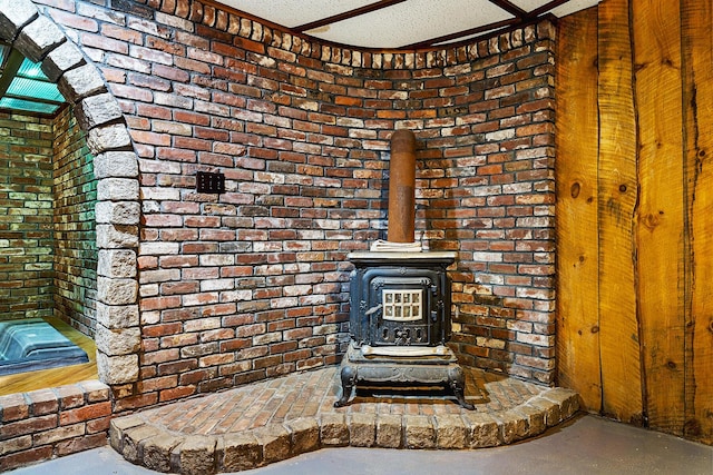 interior details with a textured ceiling and a wood stove