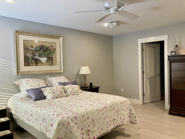 bedroom with ceiling fan and light hardwood / wood-style floors