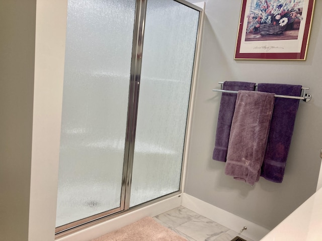 bathroom with a shower with shower door