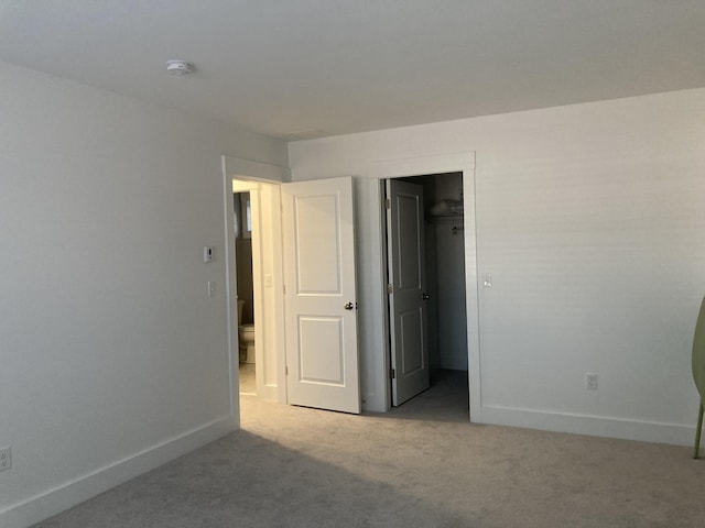 unfurnished bedroom featuring light carpet