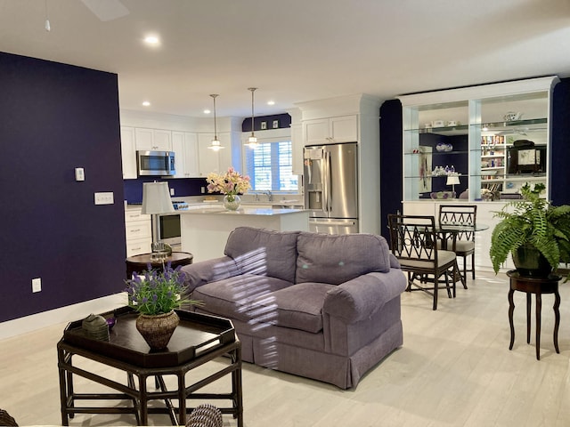 living room with sink and light hardwood / wood-style floors