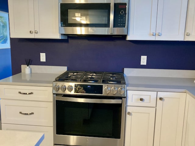 kitchen featuring appliances with stainless steel finishes and white cabinetry