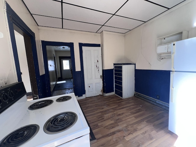 kitchen with electric range, white cabinets, dark hardwood / wood-style flooring, white fridge, and a drop ceiling