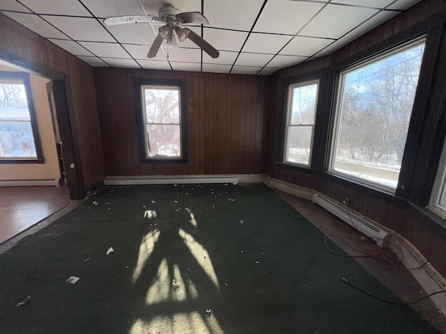 spare room featuring ceiling fan, a paneled ceiling, and a baseboard radiator