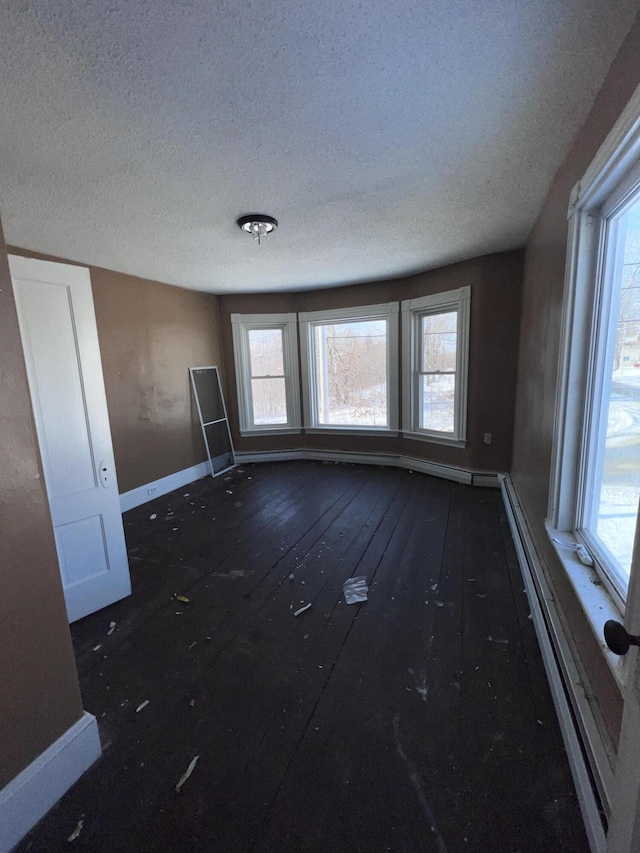 empty room featuring plenty of natural light and a textured ceiling