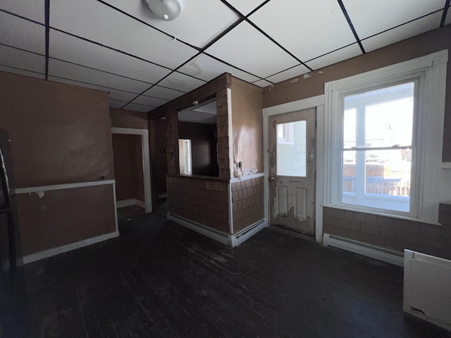 foyer with a paneled ceiling, dark hardwood / wood-style floors, and a baseboard heating unit