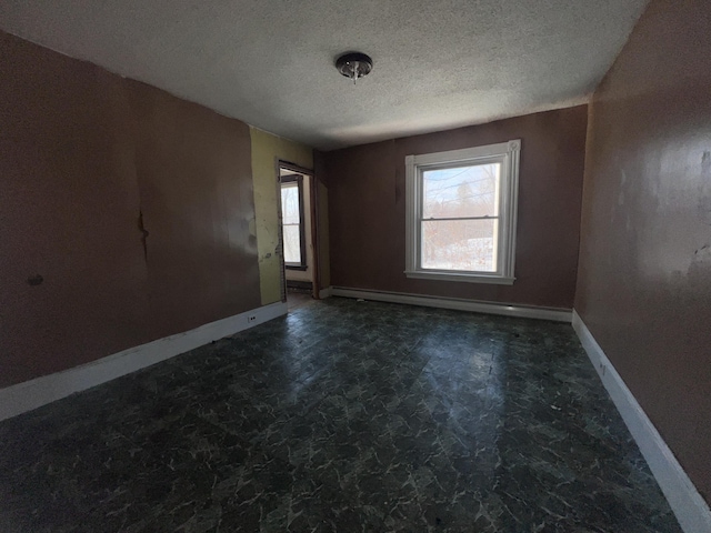 unfurnished room featuring a textured ceiling and a baseboard radiator