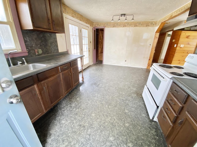 kitchen featuring sink, electric stove, and a textured ceiling