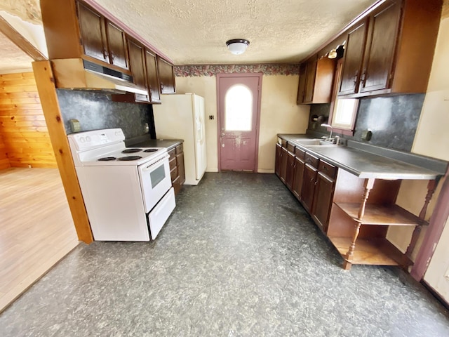 kitchen featuring white appliances, a textured ceiling, and sink