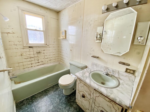 full bathroom with toilet, vanity, tile walls, a textured ceiling, and shower / tub combination