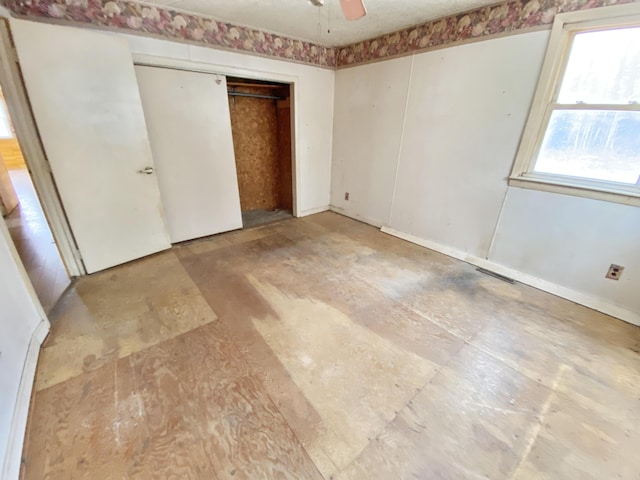 unfurnished bedroom with a closet and ceiling fan