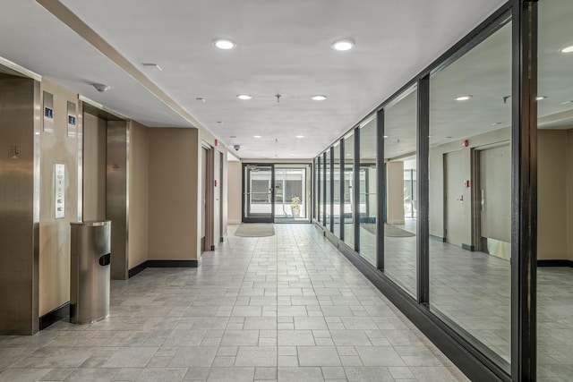 hallway featuring a wall of windows