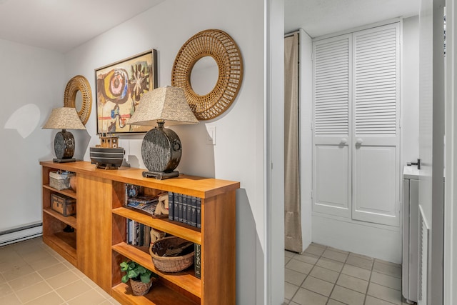 corridor with light tile patterned floors and a baseboard radiator