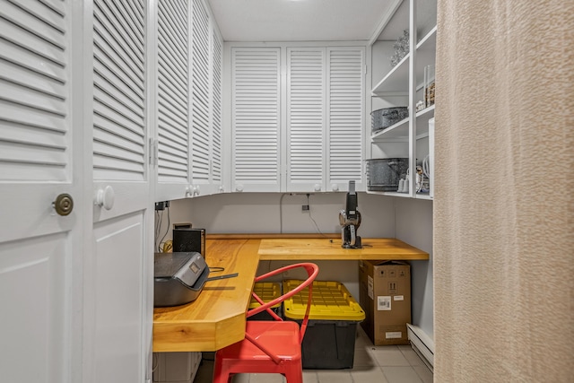 tiled home office featuring a baseboard radiator